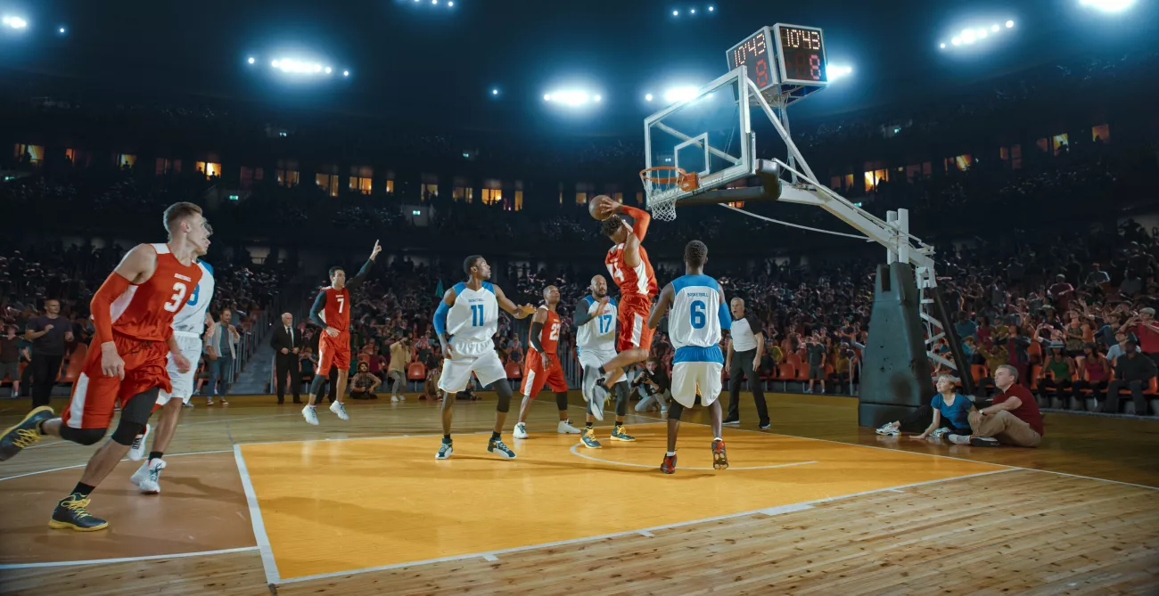Basketball players are set on a professional basketball court.