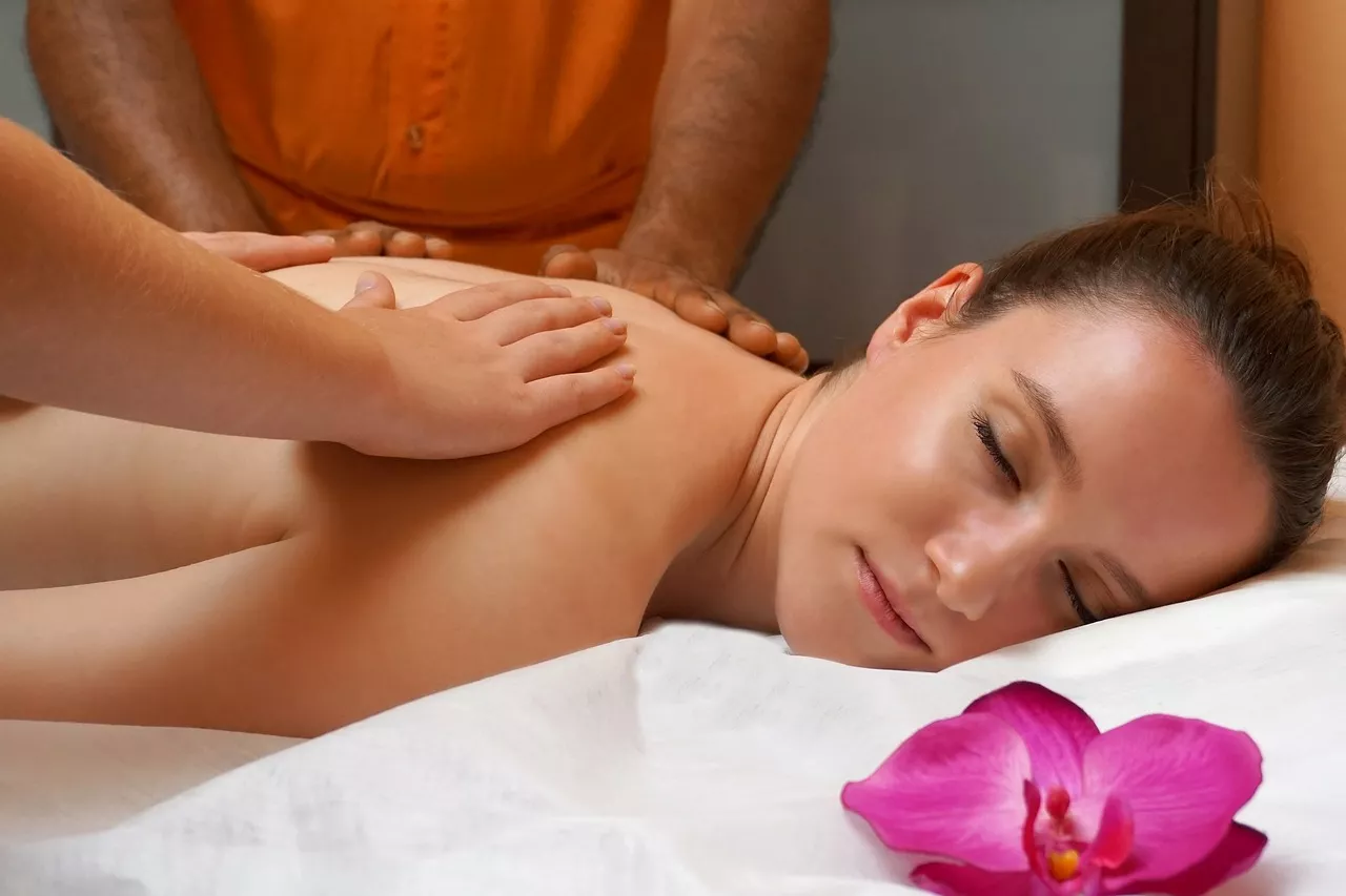 A woman lays on a massage table getting the ultimate pampering experience.
